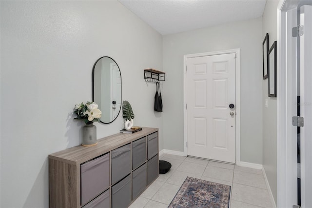 tiled entrance foyer with a textured ceiling