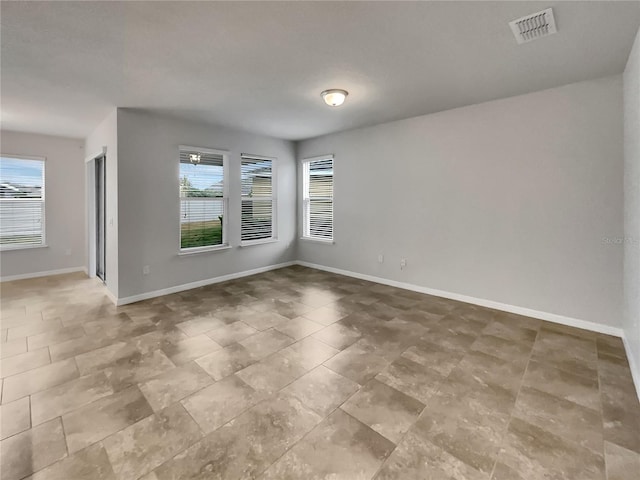 unfurnished room featuring a healthy amount of sunlight