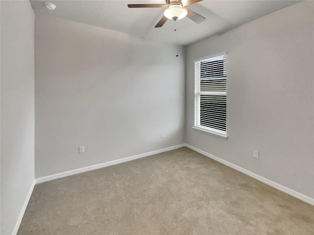 empty room featuring light carpet and ceiling fan