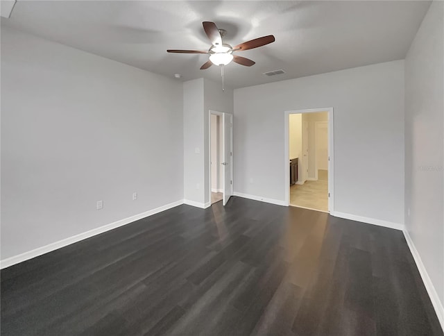 unfurnished room with ceiling fan and dark hardwood / wood-style flooring