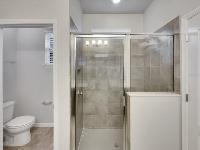 bathroom with tile patterned flooring, toilet, and walk in shower