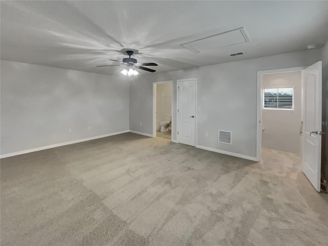 unfurnished bedroom featuring connected bathroom, ceiling fan, and light colored carpet