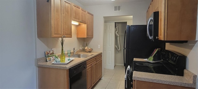 kitchen featuring light tile patterned flooring, sink, and black appliances