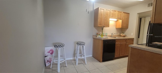 kitchen with light tile patterned floors, sink, and black appliances