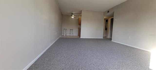 carpeted empty room featuring ceiling fan