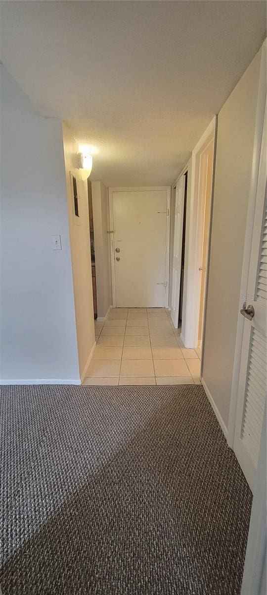 hallway with light tile patterned floors