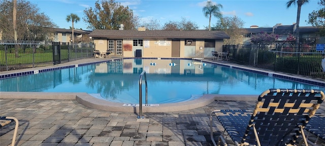 view of pool featuring a patio area and an outbuilding