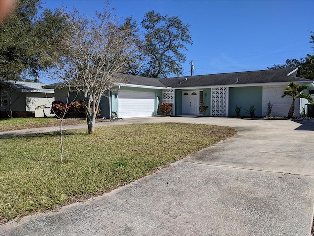 ranch-style house featuring a garage and a front lawn