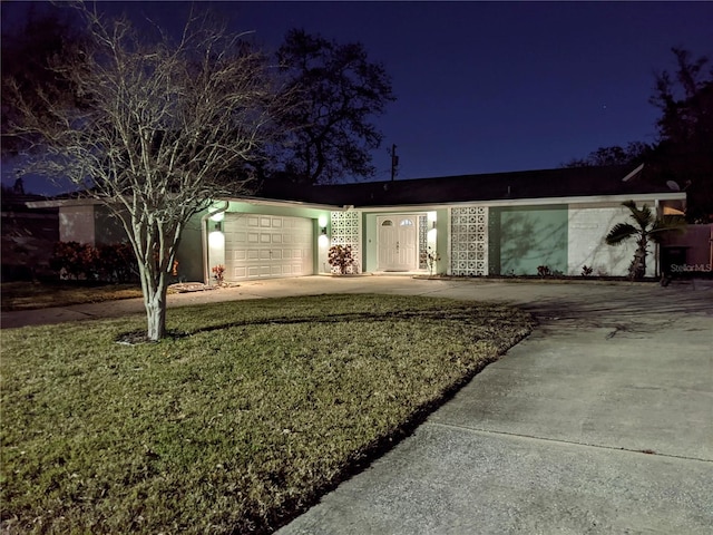 single story home with a yard and a garage