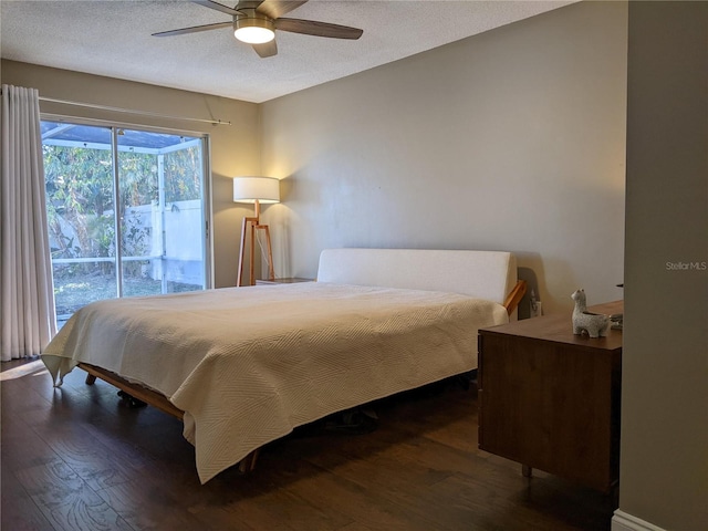 bedroom with access to outside, ceiling fan, dark hardwood / wood-style flooring, and a textured ceiling