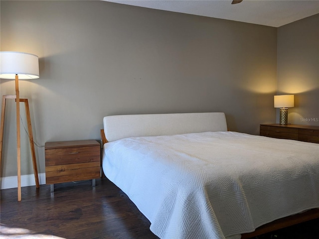 bedroom featuring ceiling fan and dark wood-type flooring