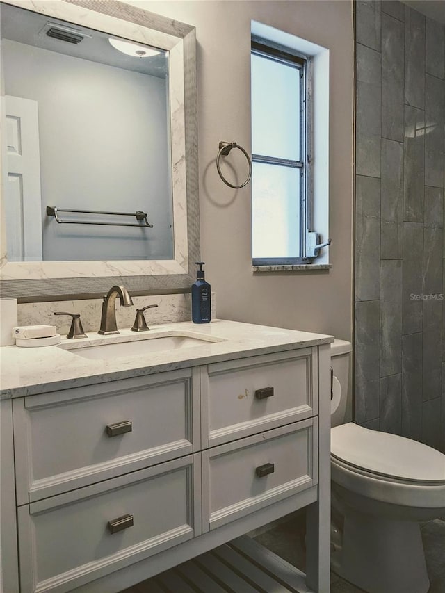 bathroom with vanity and toilet