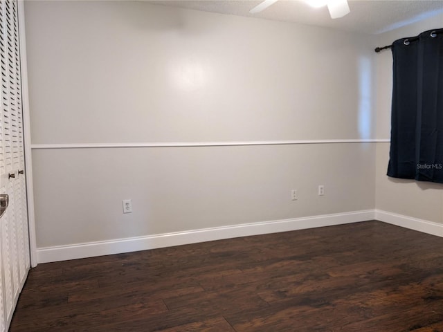 spare room with ceiling fan, dark hardwood / wood-style flooring, and a textured ceiling