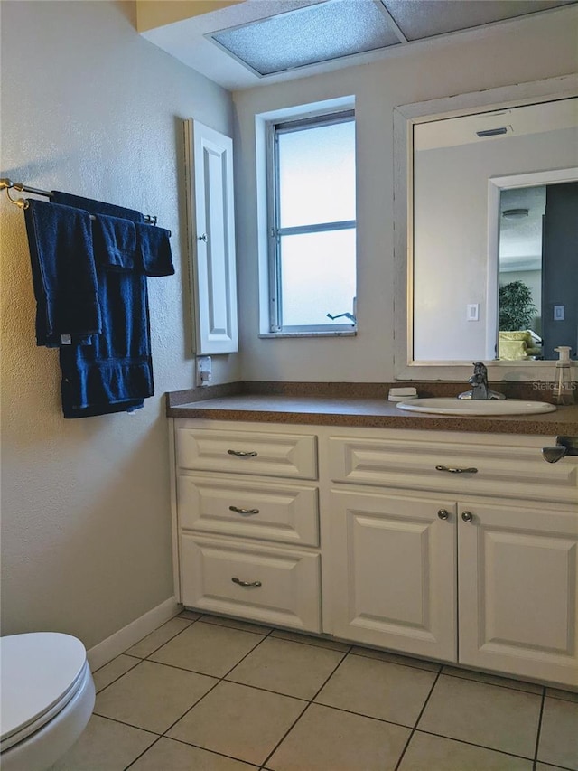 bathroom featuring toilet, vanity, and tile patterned floors