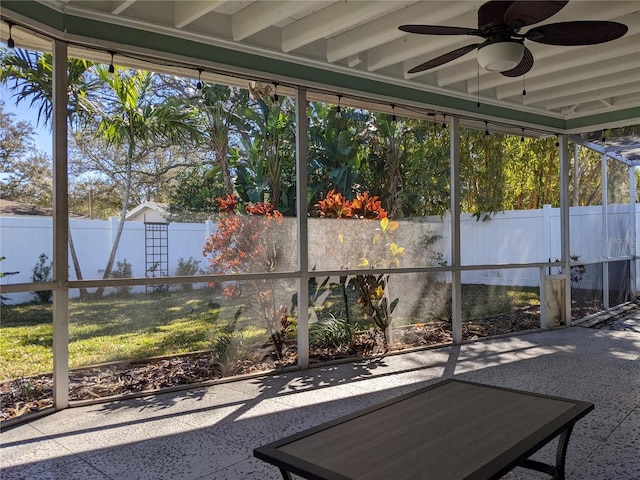 unfurnished sunroom featuring ceiling fan