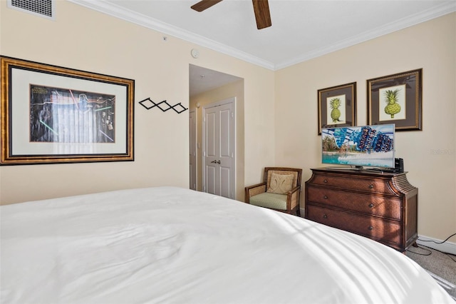 bedroom featuring crown molding, carpet floors, and ceiling fan