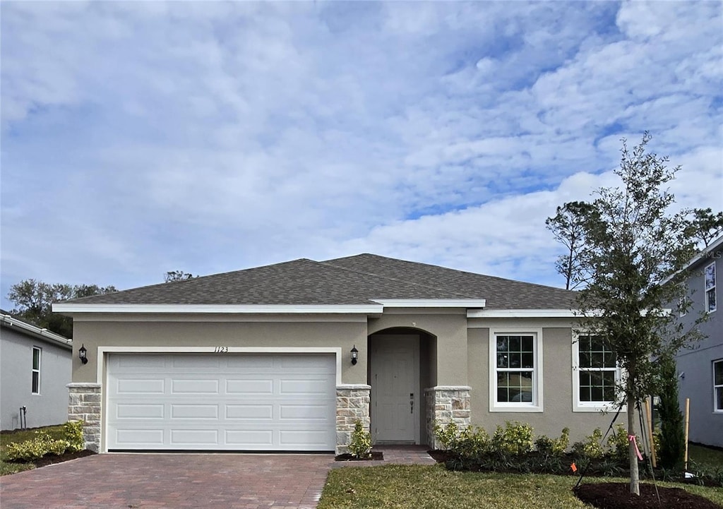 view of front of house with a garage and a front lawn