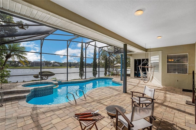 view of swimming pool with glass enclosure, a water view, an in ground hot tub, and a patio