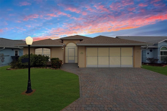 view of front of house with a yard and a garage