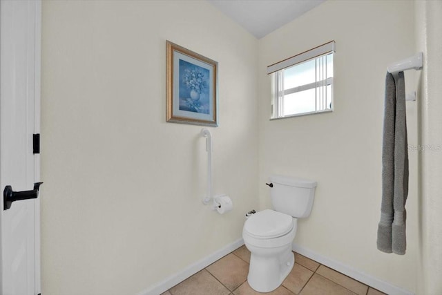 bathroom with tile patterned flooring and toilet