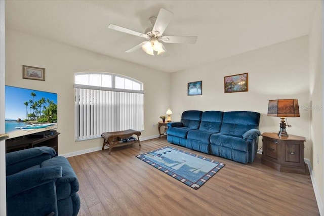 living room with light wood-type flooring and ceiling fan