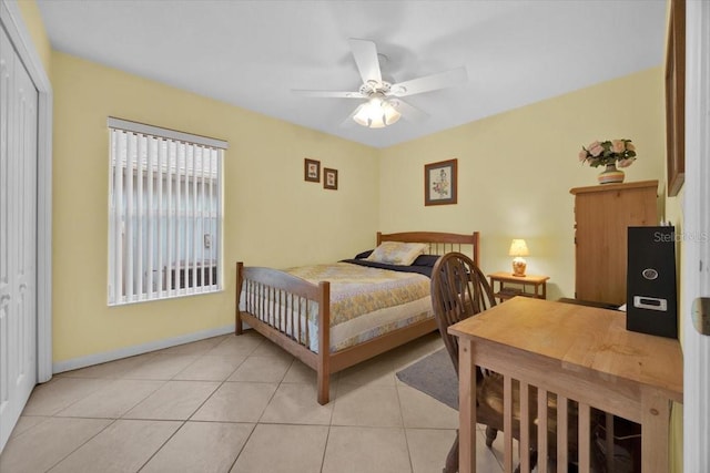 bedroom with ceiling fan, a closet, and light tile patterned floors