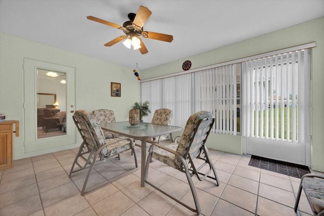 tiled dining space featuring ceiling fan