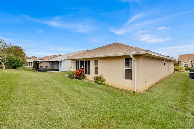 rear view of property featuring a lawn