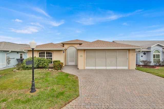 ranch-style house featuring a front yard and a garage