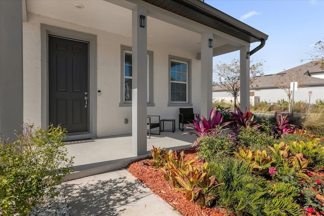 entrance to property featuring covered porch