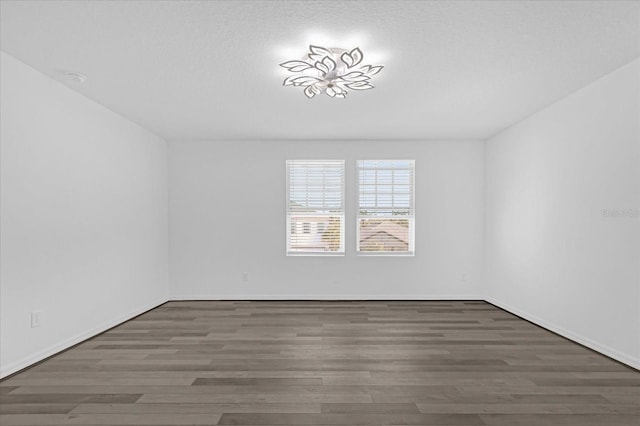 empty room with dark hardwood / wood-style floors