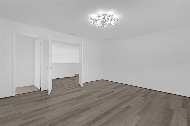 empty room featuring dark wood-type flooring