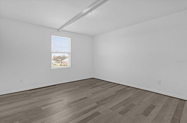 empty room with wood-type flooring