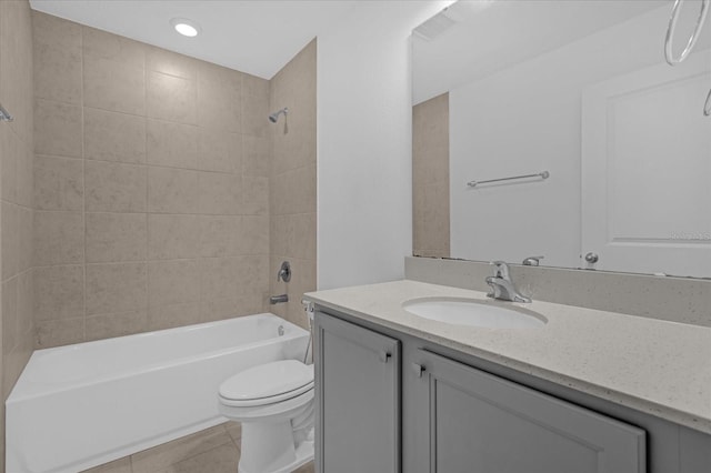 full bathroom featuring vanity, tiled shower / bath combo, tile patterned floors, and toilet