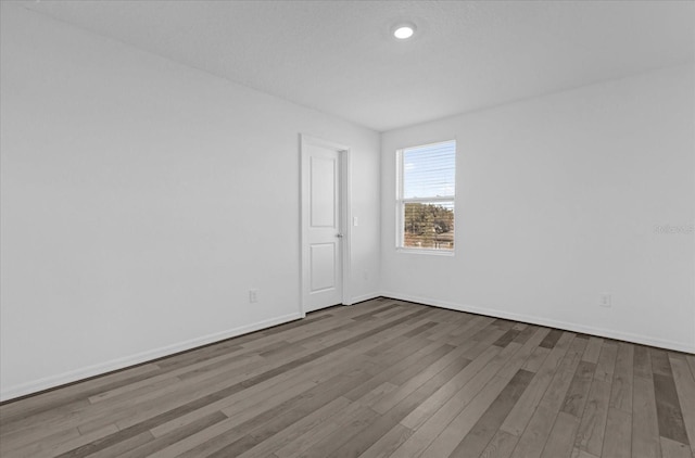 spare room featuring hardwood / wood-style floors