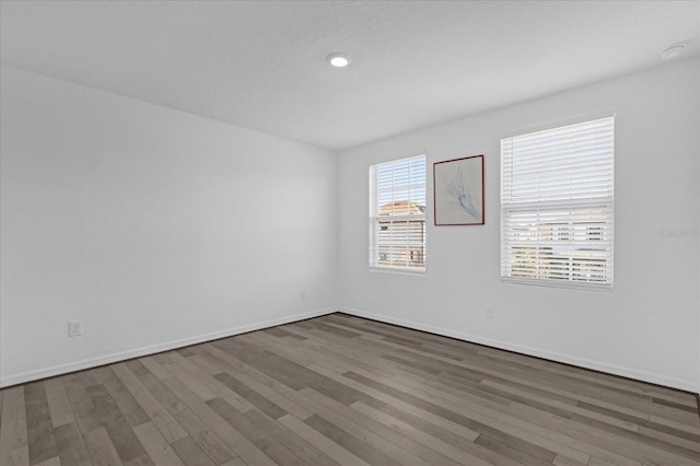 empty room featuring dark wood-type flooring