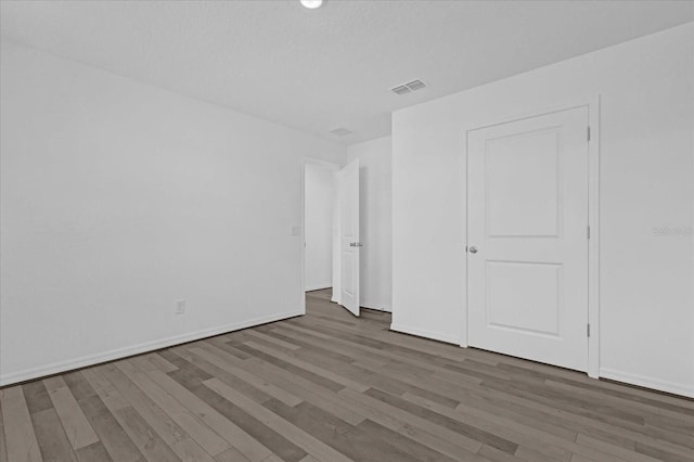 unfurnished bedroom with dark hardwood / wood-style floors