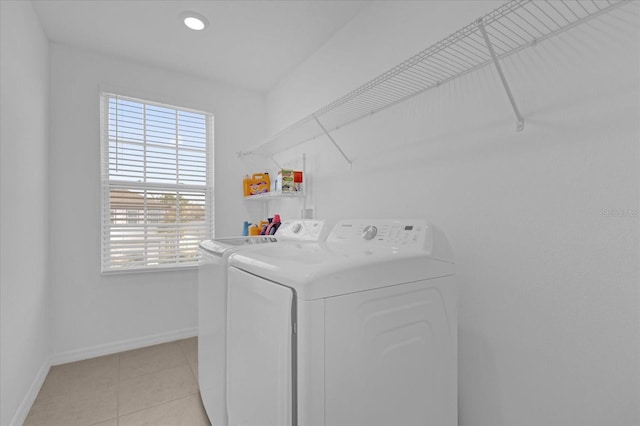 laundry area featuring independent washer and dryer and light tile patterned flooring