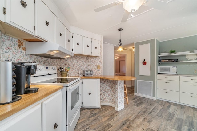 kitchen featuring pendant lighting, premium range hood, white appliances, and white cabinetry