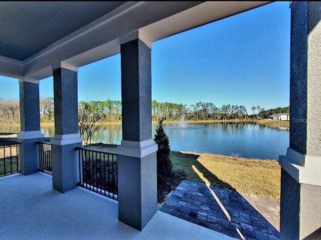 view of patio with a water view