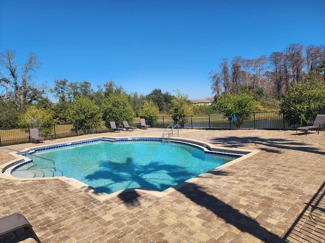 view of swimming pool with a patio area