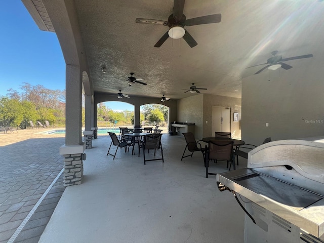 view of patio featuring area for grilling and ceiling fan