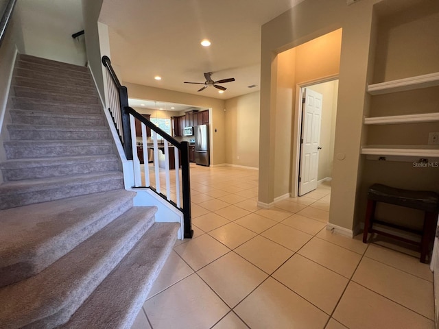 stairs featuring ceiling fan, tile patterned flooring, and built in features