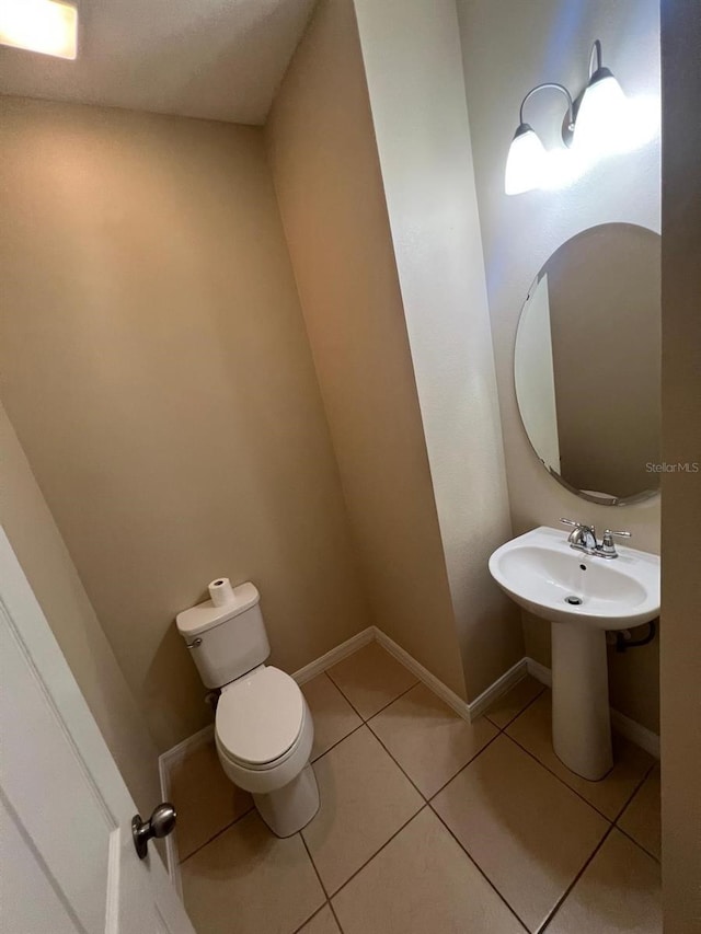 bathroom with sink, tile patterned floors, and toilet