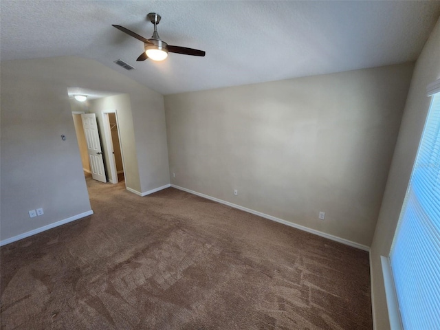 carpeted empty room featuring vaulted ceiling and ceiling fan