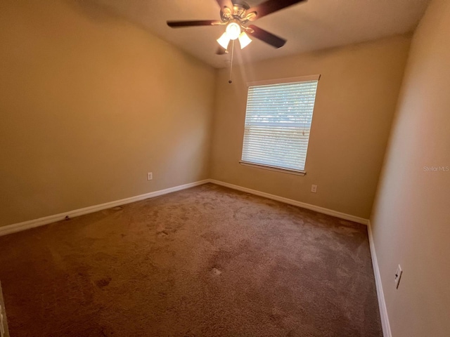 unfurnished room with ceiling fan and carpet flooring