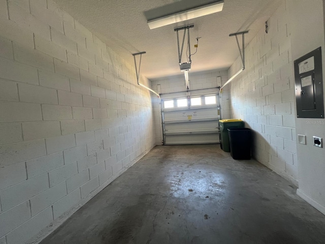 garage with a garage door opener and electric panel