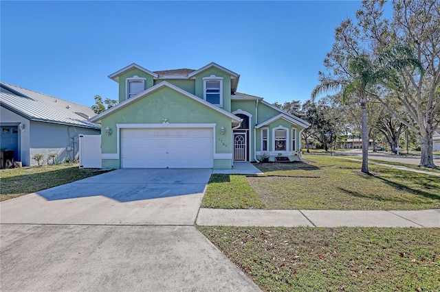 view of front of home with a garage and a front lawn