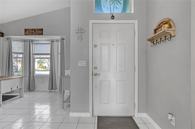 tiled foyer entrance with lofted ceiling