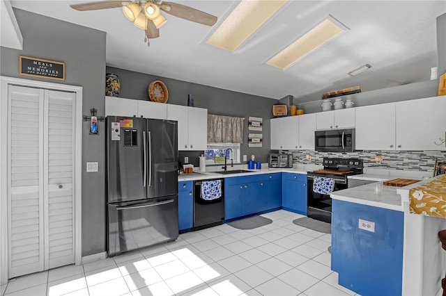 kitchen featuring stainless steel appliances, blue cabinets, sink, white cabinetry, and decorative backsplash